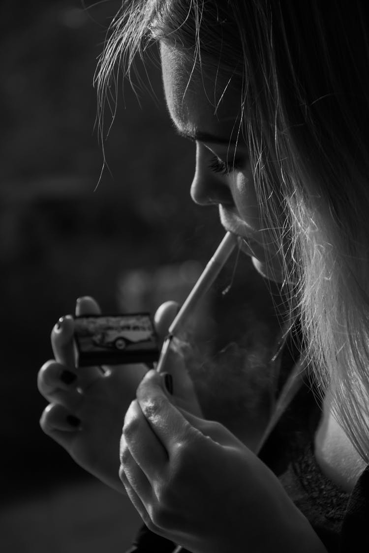 A Woman Lighting A Cigarette 