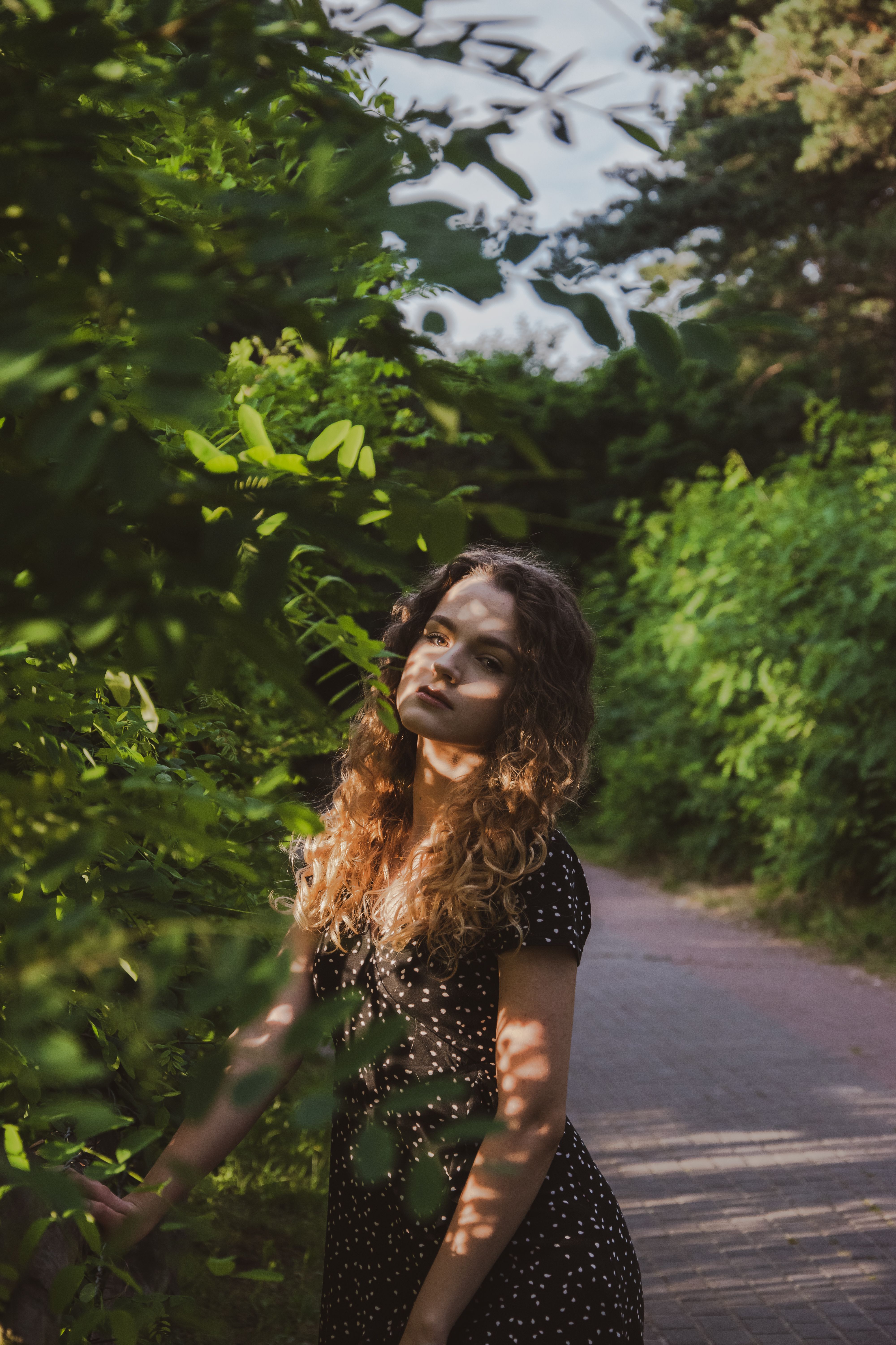 Woman in Black Dress Holding a Bicycle · Free Stock Photo