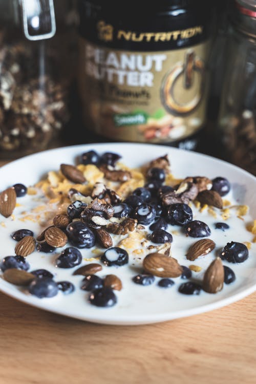 Healthy Cereal Breakfast With Blueberries and Almonds On Ceramic Bowl