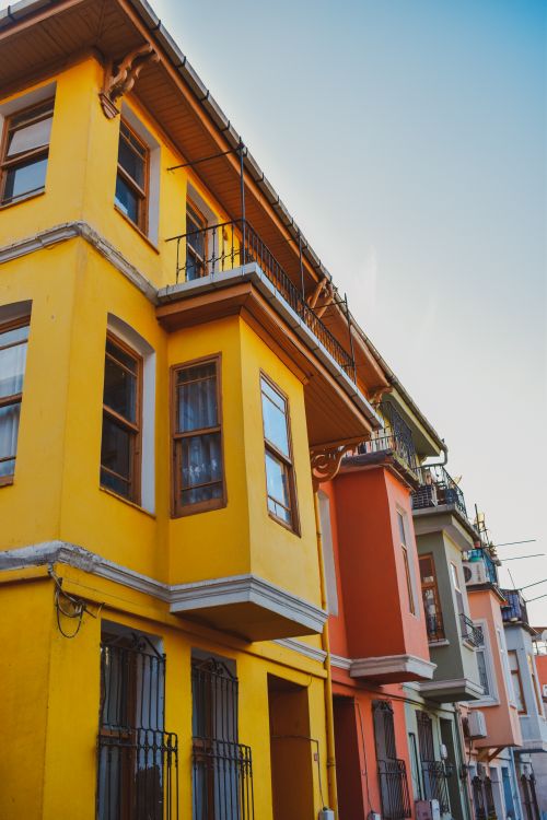 Free Vibrant colorful buildings with unique architecture under a clear sky, showcasing an urban residential area. Stock Photo