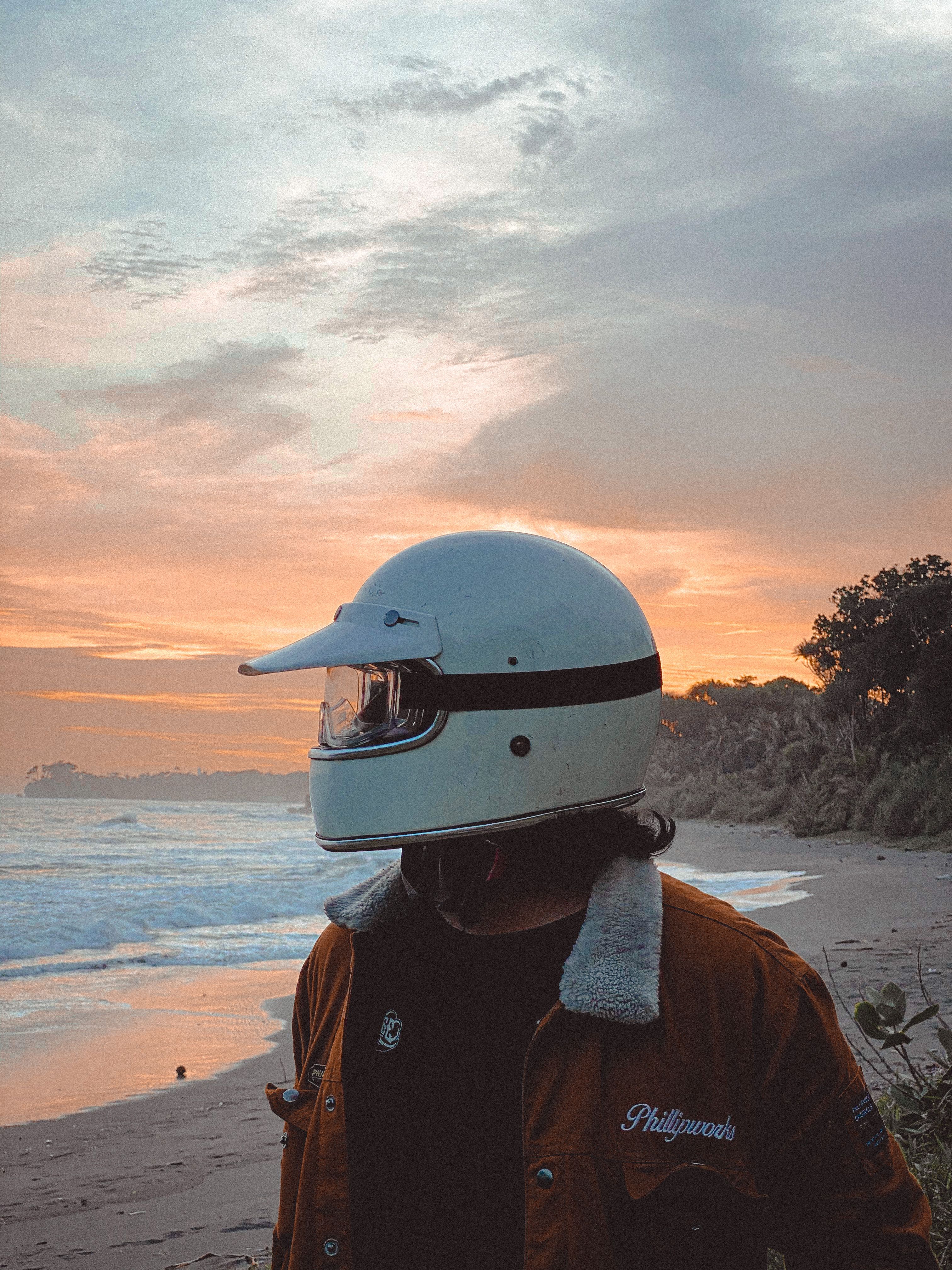 beach motorcycle helmet Man Wearing White Motorcycle Helmet on the Beach during Sunset · Free Stock  Photo