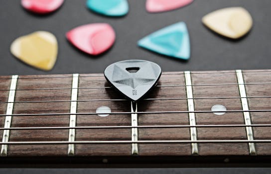 Detailed view of a guitar fretboard with colorful plectrums on a dark background.