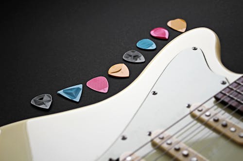 Free Close-Up Shot of Guitar Picks beside an Electric Guitar Stock Photo