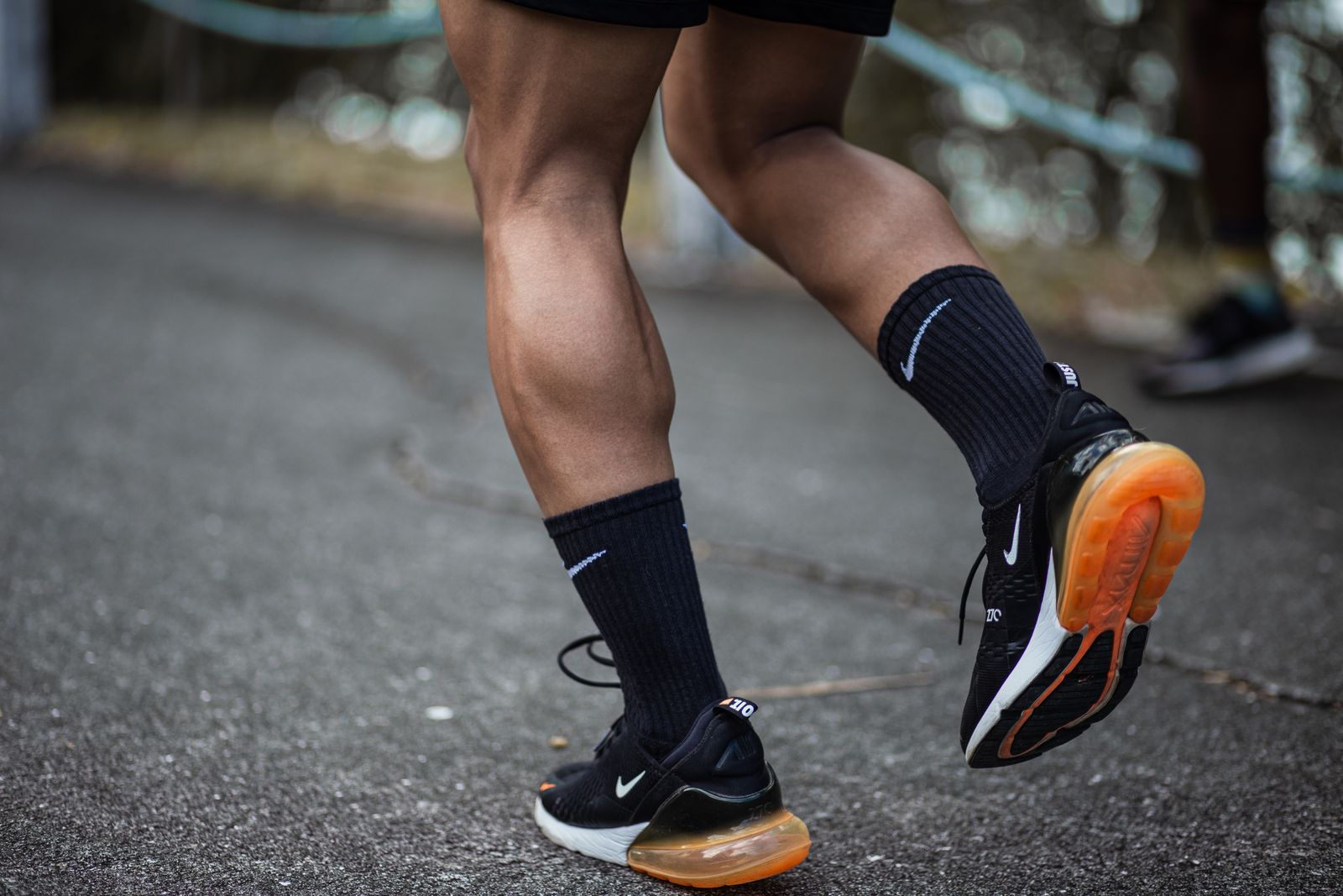 Runner outdoors adjusting a knee support before activity