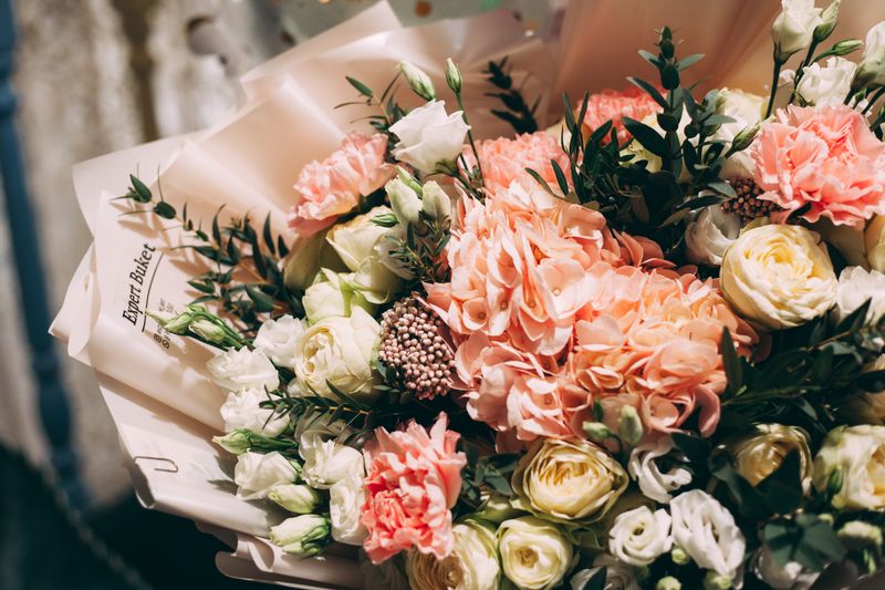 Hand-tied seasonal bouquet being finished by an artisan florist in Charleston