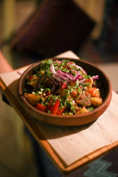 Mouthwatering close-up of a gourmet dish with vibrant ingredients on a wooden board.
