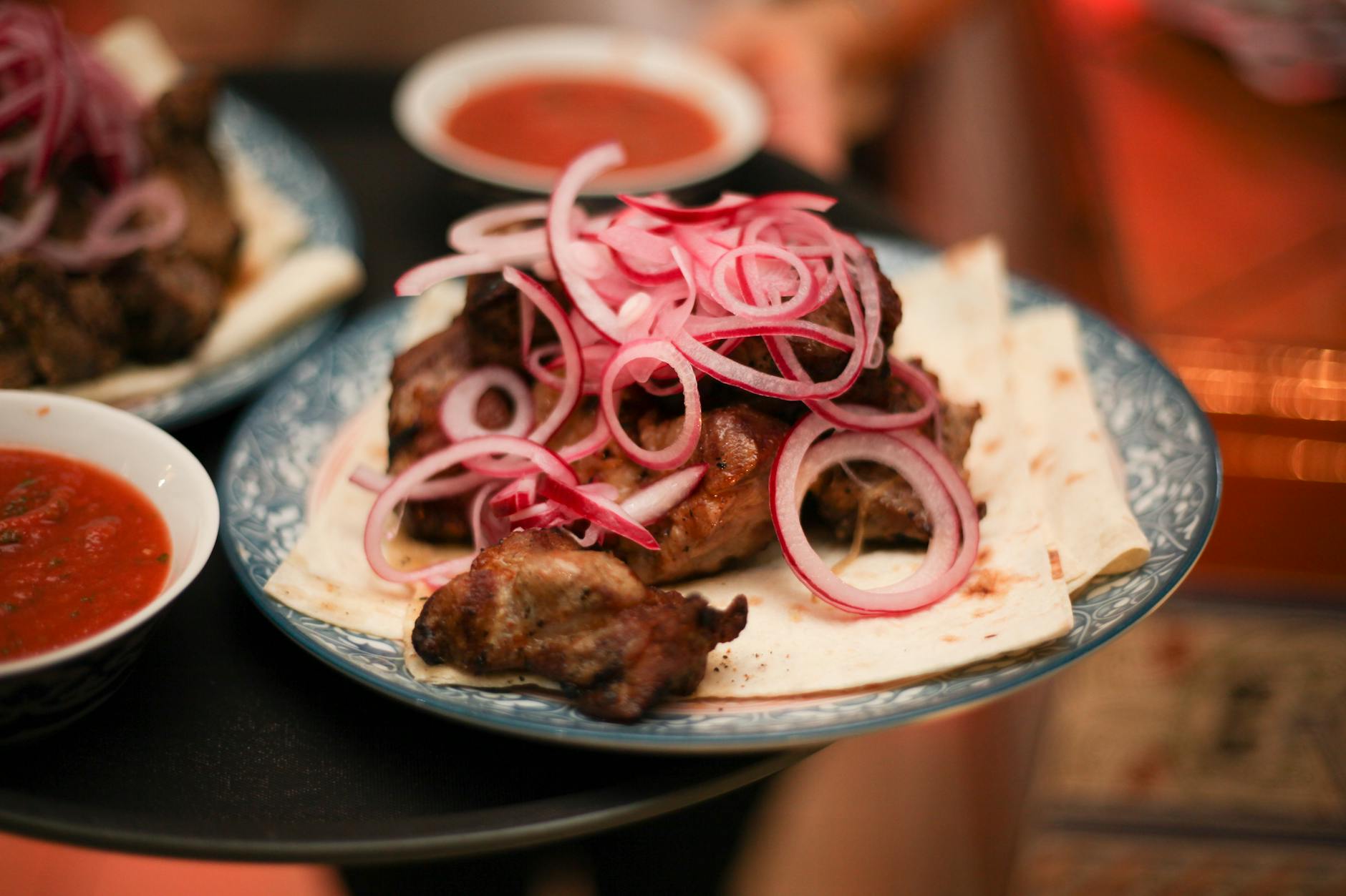 https://www.pexels.com/photo/close-up-of-meat-with-red-onion-on-top-7462844/