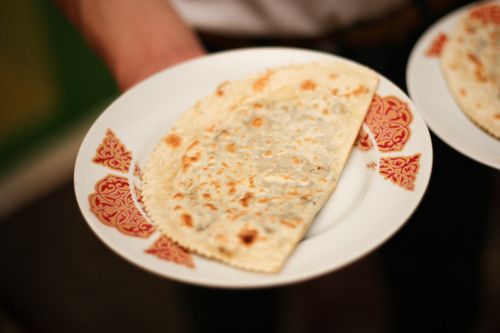 Free A detailed view of a toasted flatbread served on a decorative plate, perfect for food lovers. Stock Photo