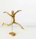Brown Wooden Human Figure on White Table
