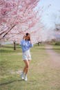 Girl Standing under the Cherry Blossom Tree