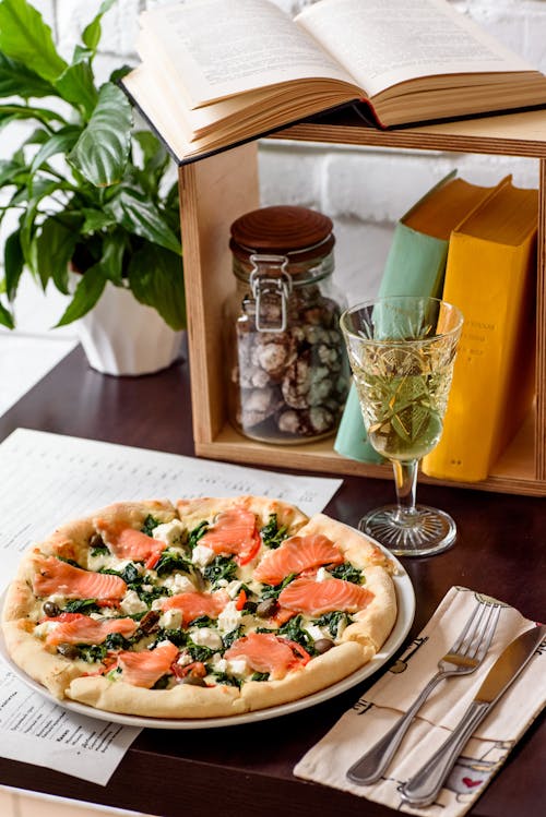 Pizza on White Ceramic Plate Beside Clear Drinking Glass