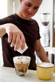 A barista crafting coffee with latte art in a cozy cafe setting, focusing on skill and presentation.