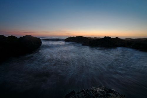 Free Peaceful sunset over the ocean at Yachats, Oregon, with gentle waves and a scenic horizon. Stock Photo