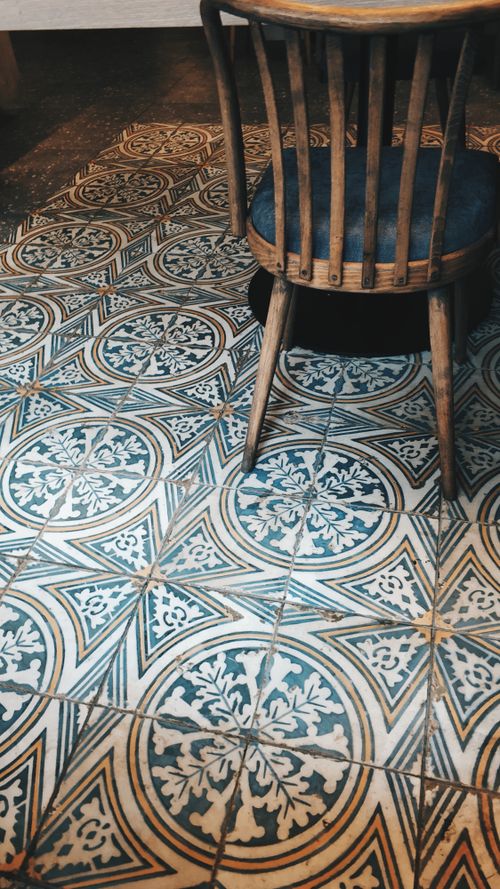 Free High angle of interior of light room with shabby tile floor with window chair Stock Photo
