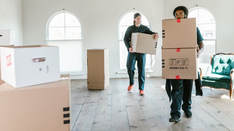 Moving Services Available in Cave Creek Cave Creek movers carrying boxes inside a residential home