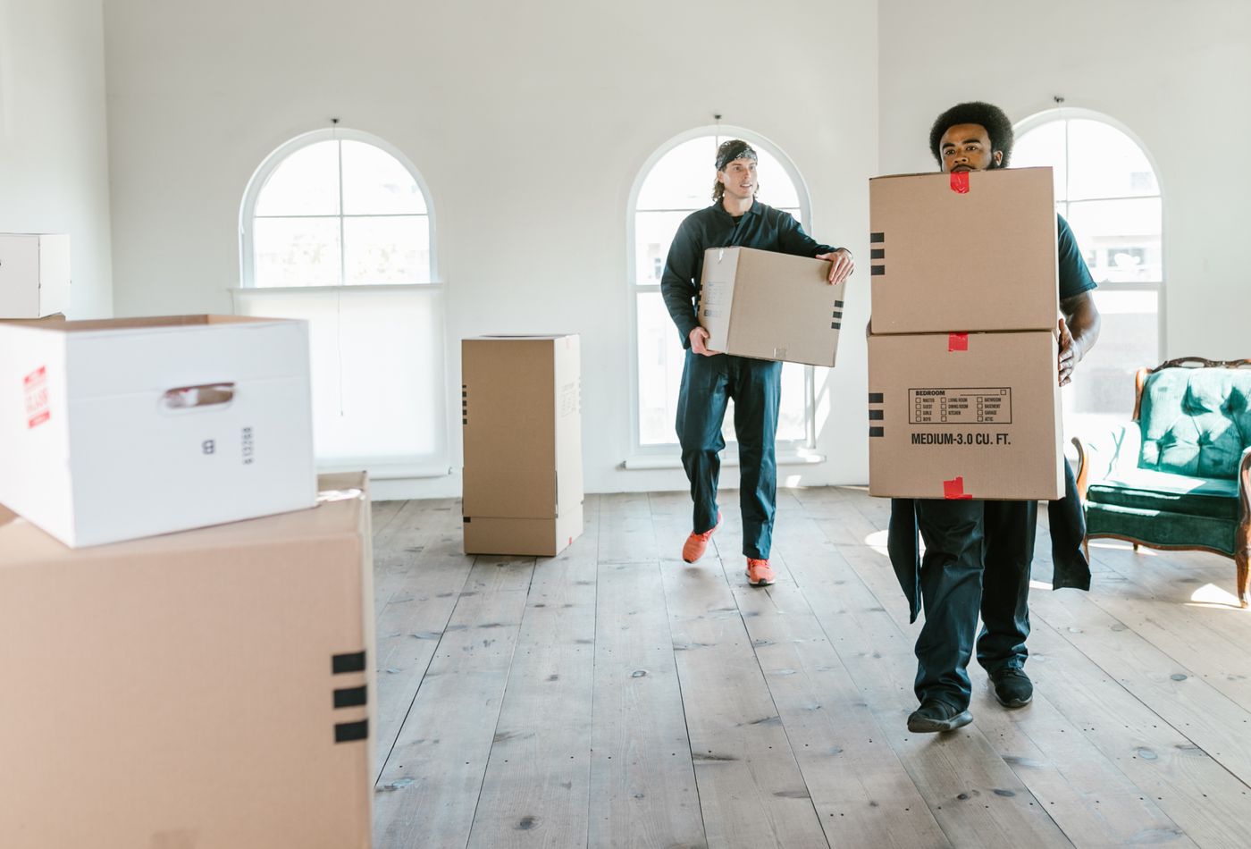 Movers wrapping furniture for international shipment from Hong Kong