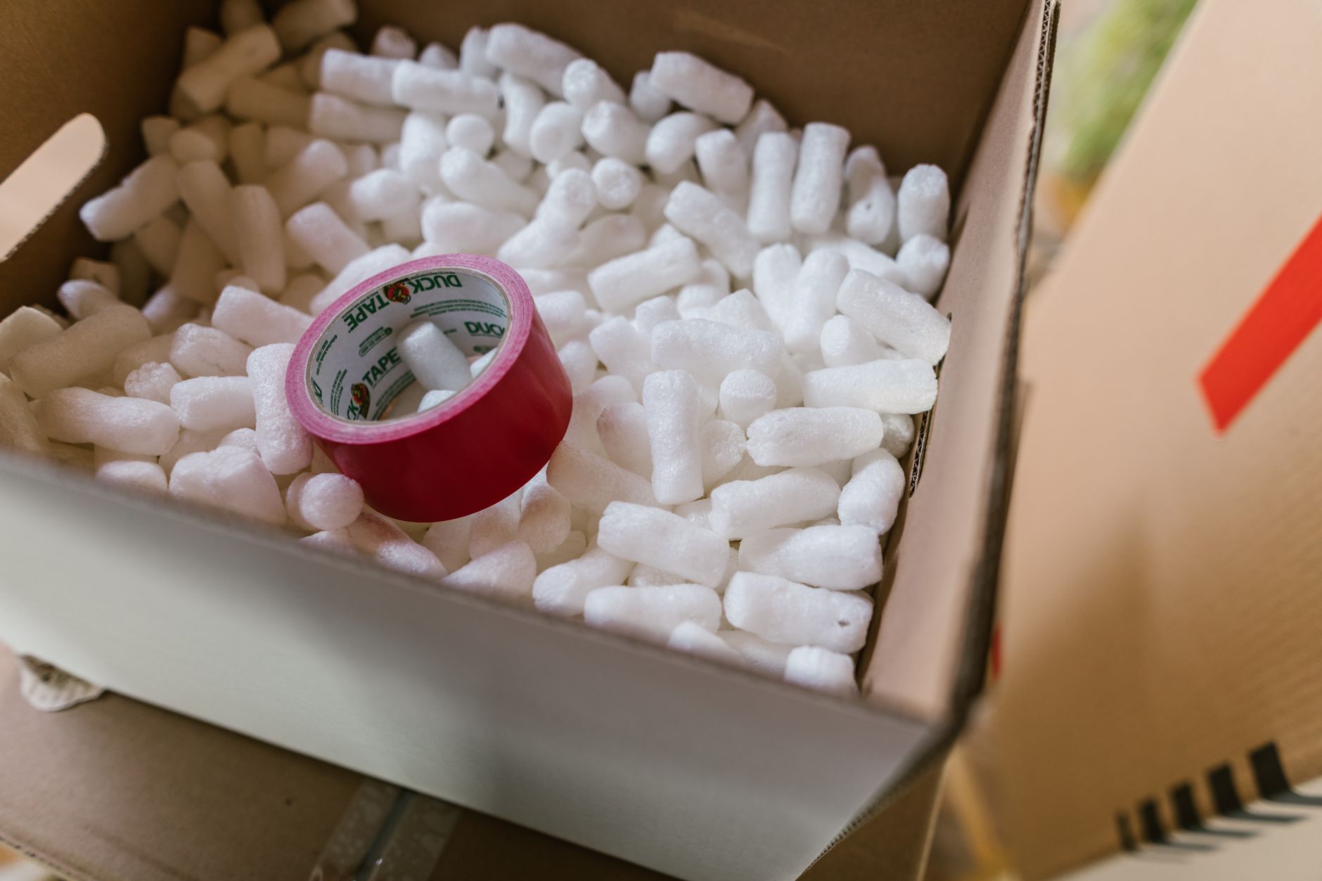 online seller packing fragile products with bubble wrap in a small warehouse