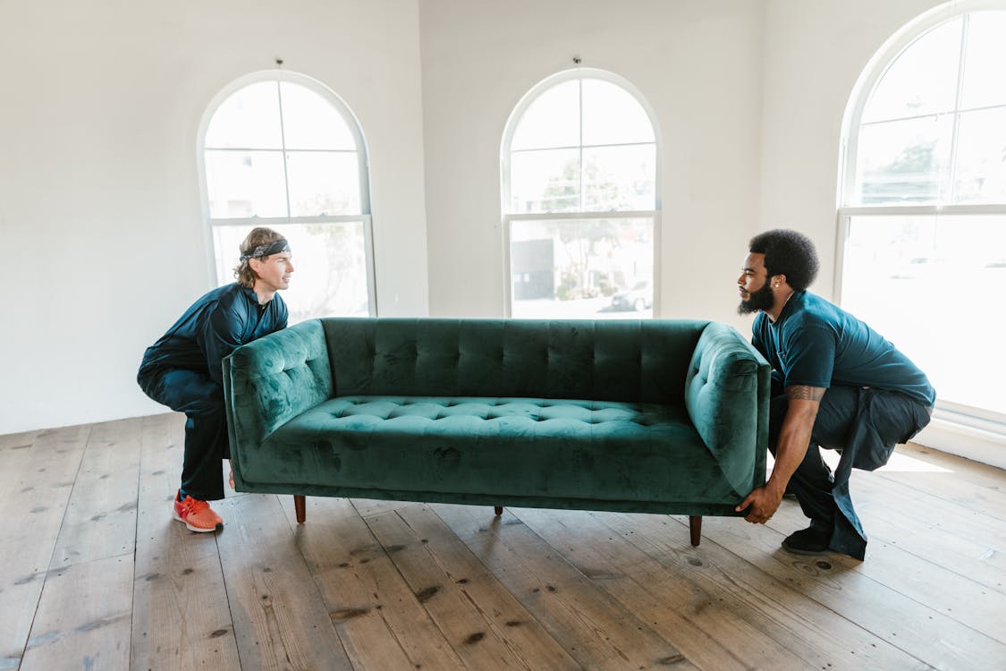 Man and Woman Sitting on Green Couch