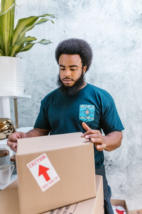 Close-Up Shot of a Man Holding a Package