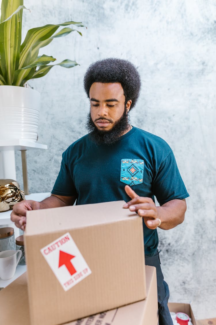 Close-Up Shot Of A Man Holding A Package