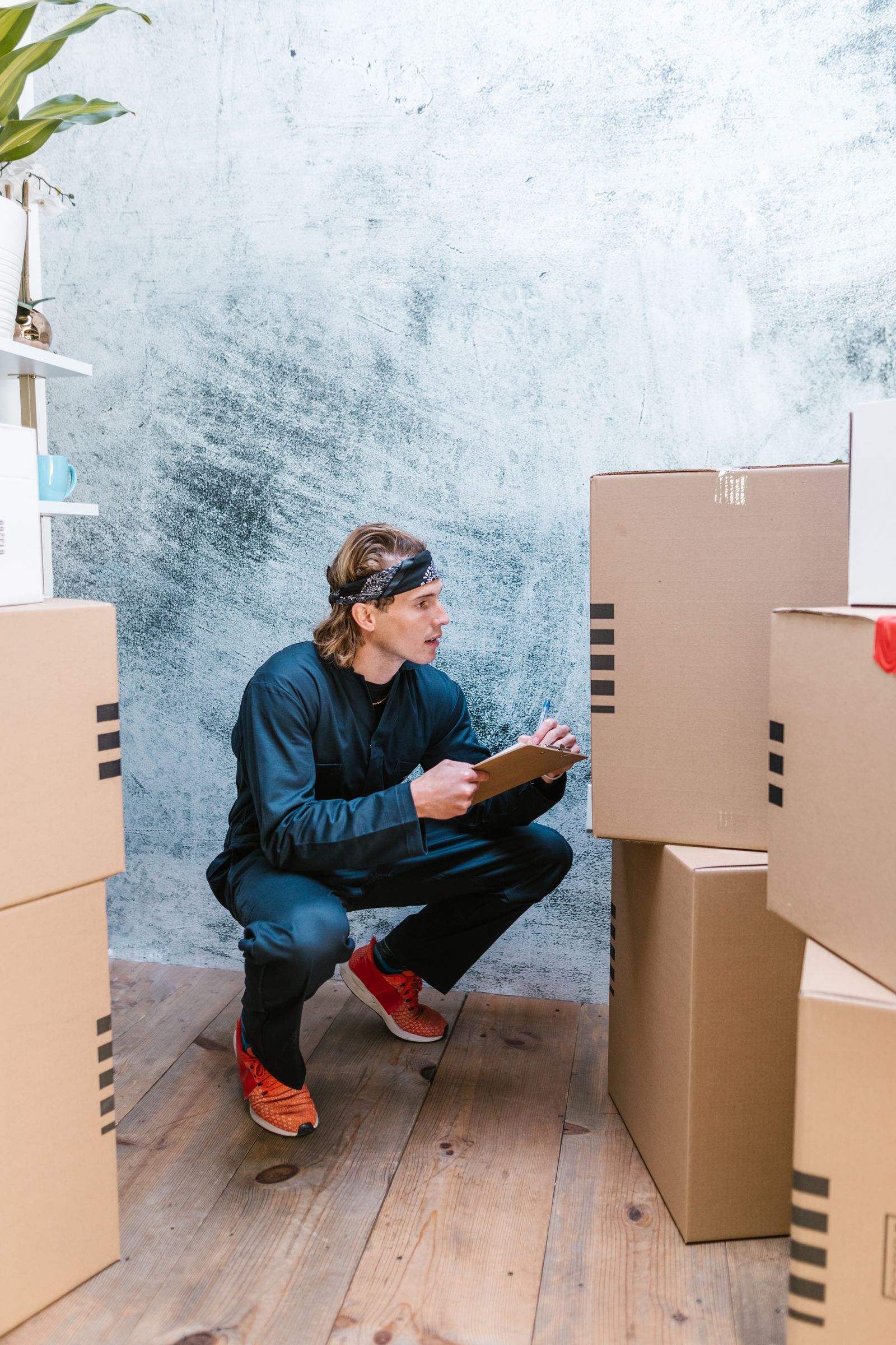 Worker checking shipping boxes with a clipboard