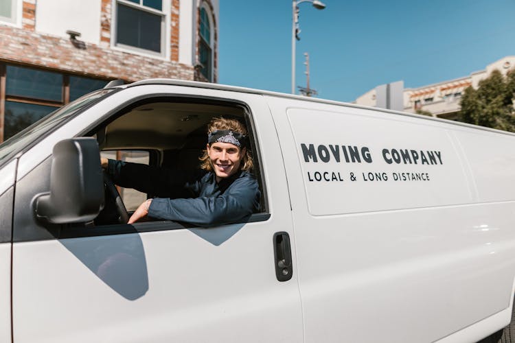 Close-Up Shot Of A Man Riding A Car Smiling