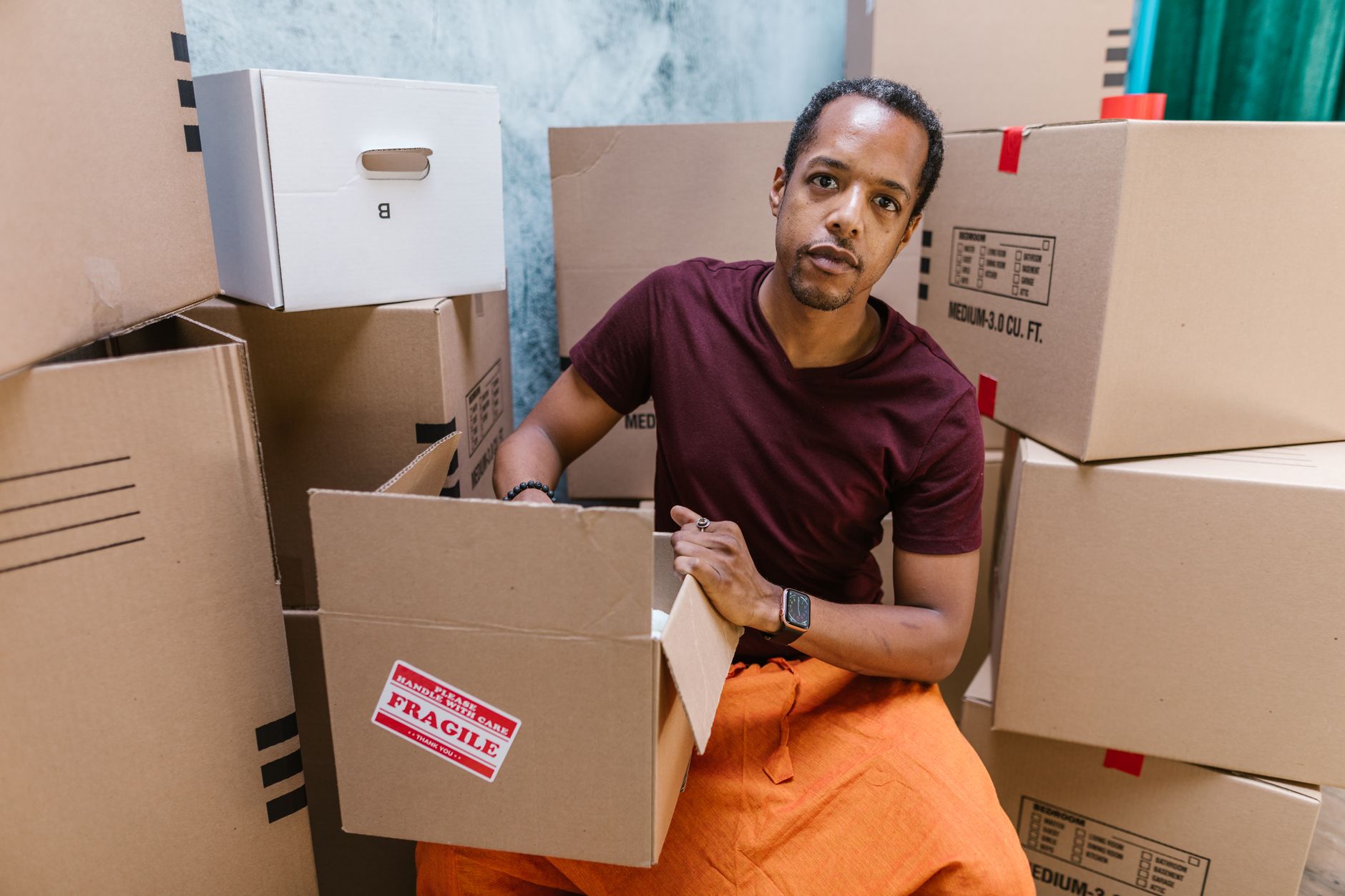 warehouse worker packing fragile items with air pillows and kraft paper
