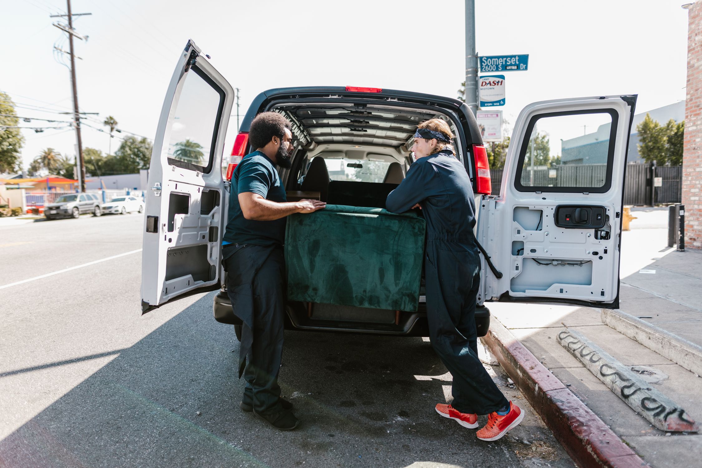 Professional movers loading furniture into a moving van