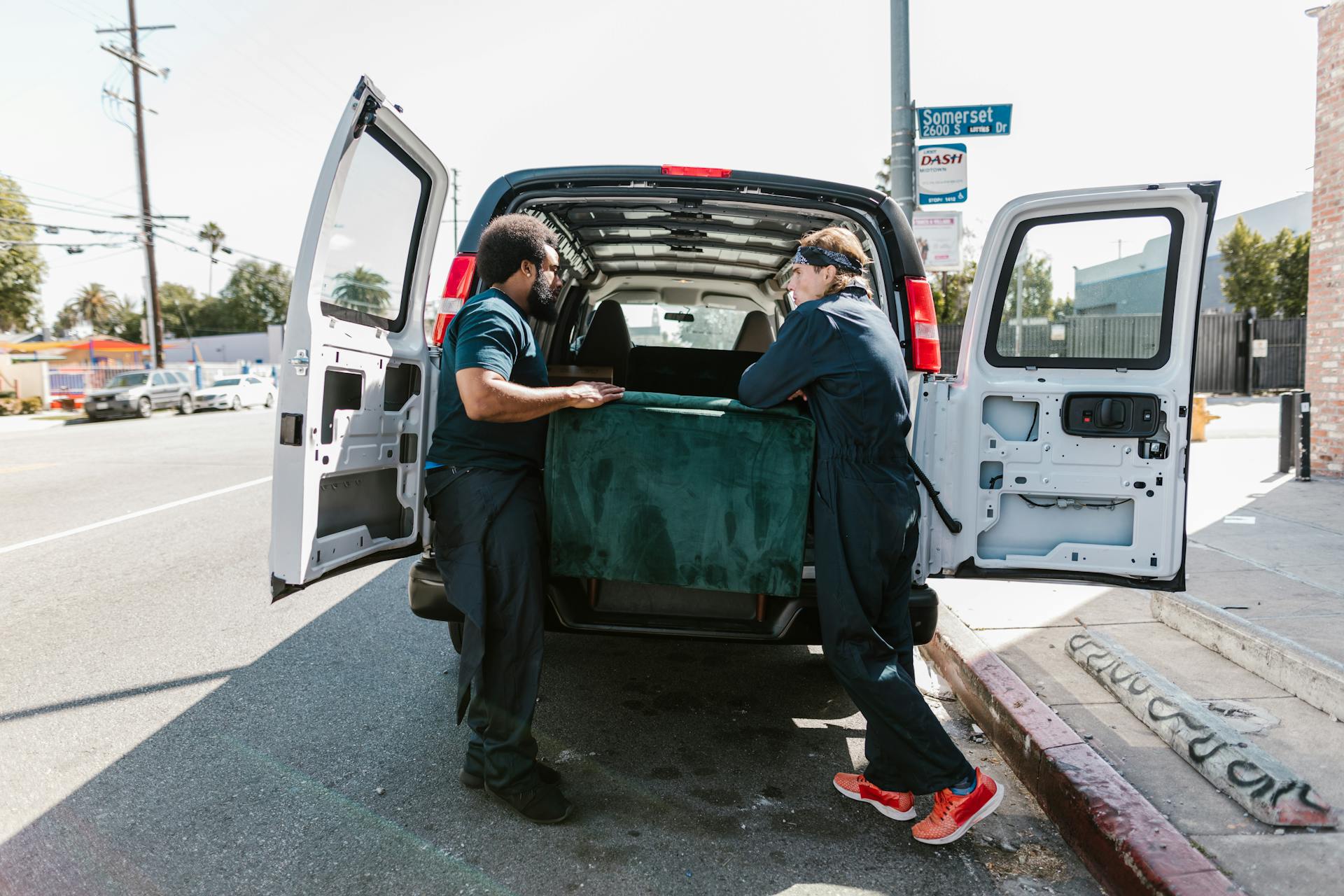 Men Putting the Green Velvet Box at the Back of the Van