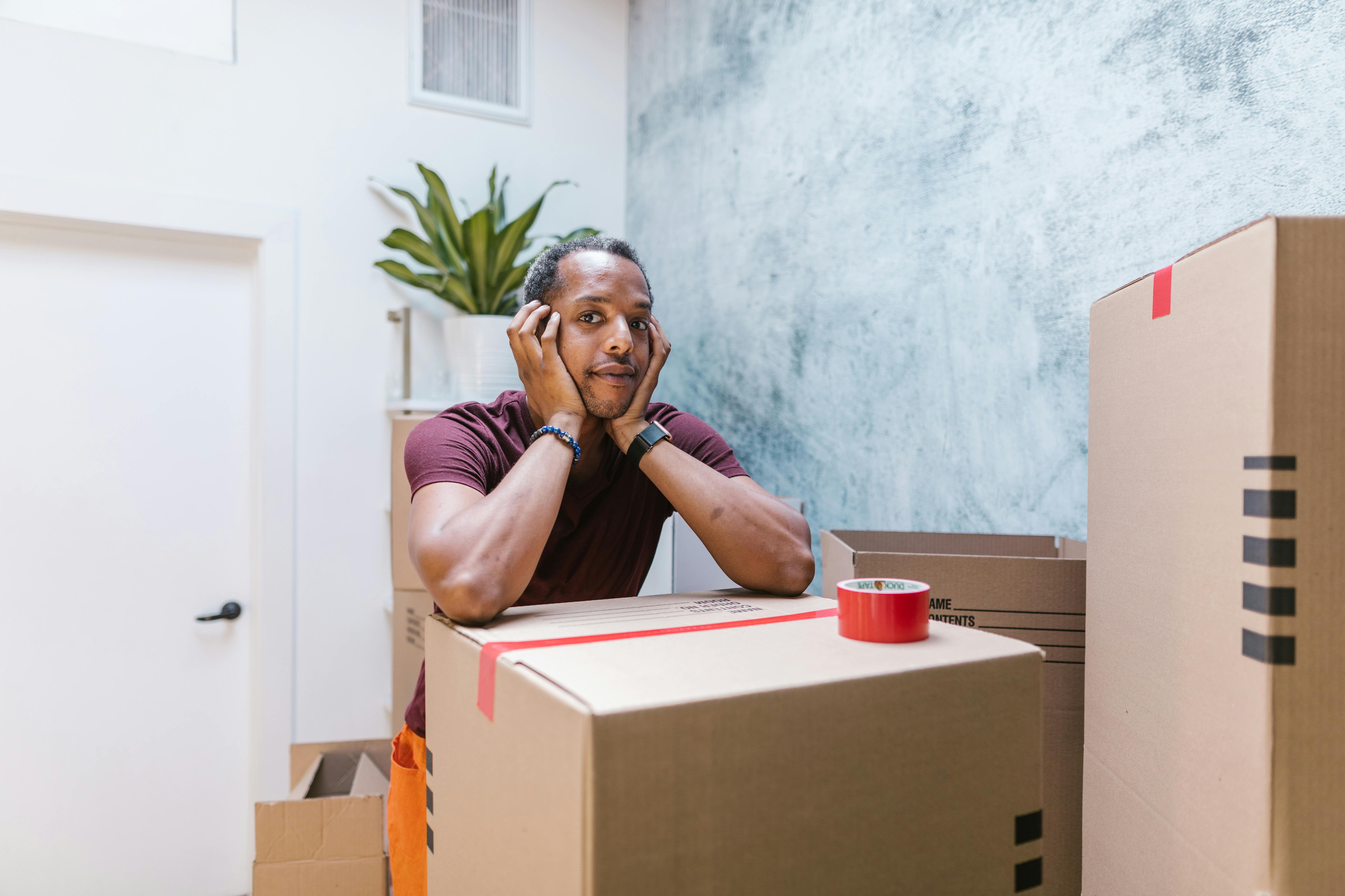 a man resting on a sealed box