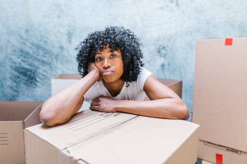 Woman Surrounded by Moving Boxes