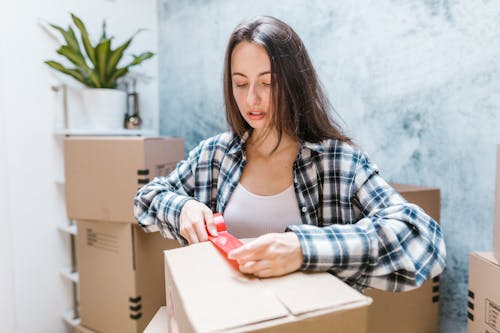 Free Woman Packing Moving Boxes Stock Photo