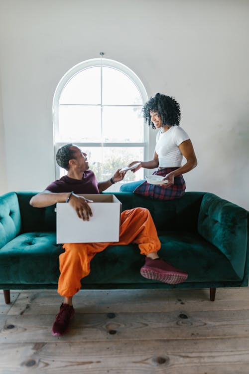 Free Full Shot of a Couple Sitting on a Couch Stock Photo