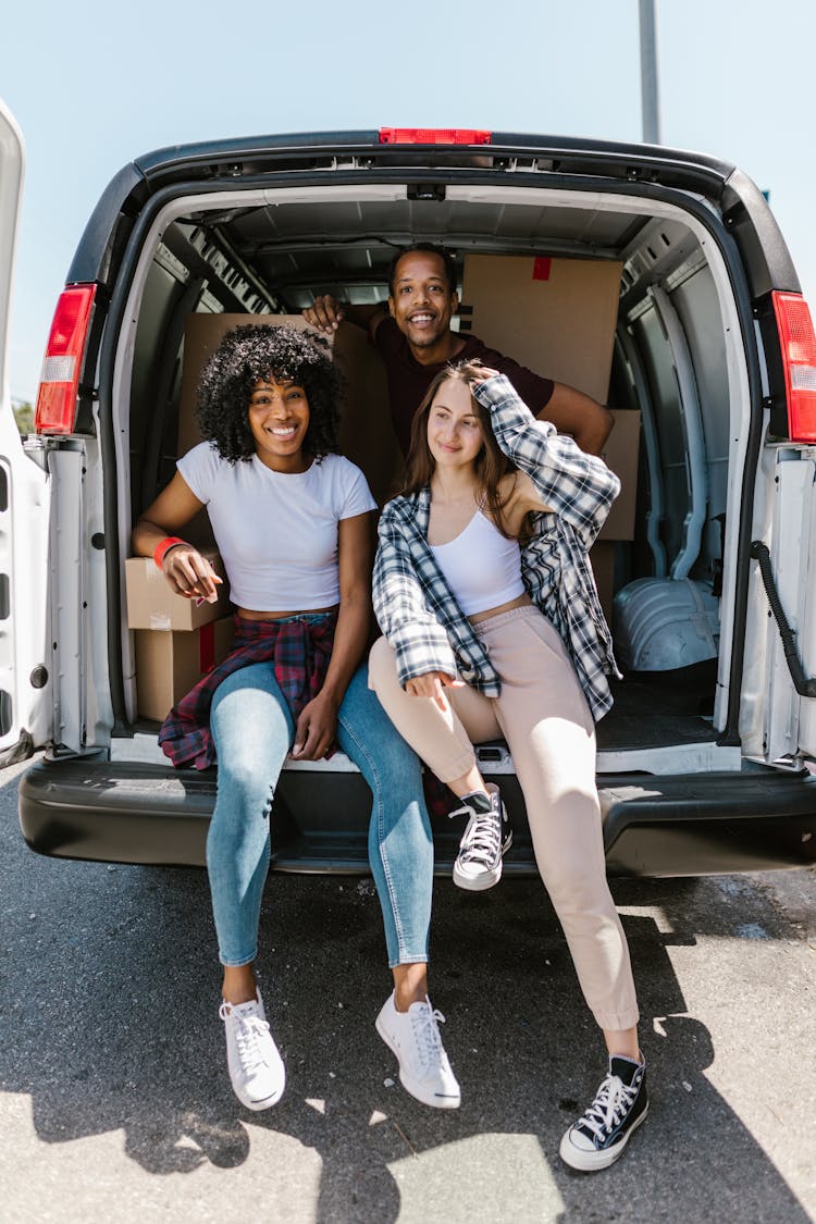 Close-Up Shot Of Friends Sitting In A Car