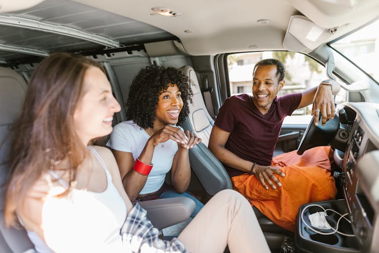 Close-Up Shot Of Friends Riding A Car