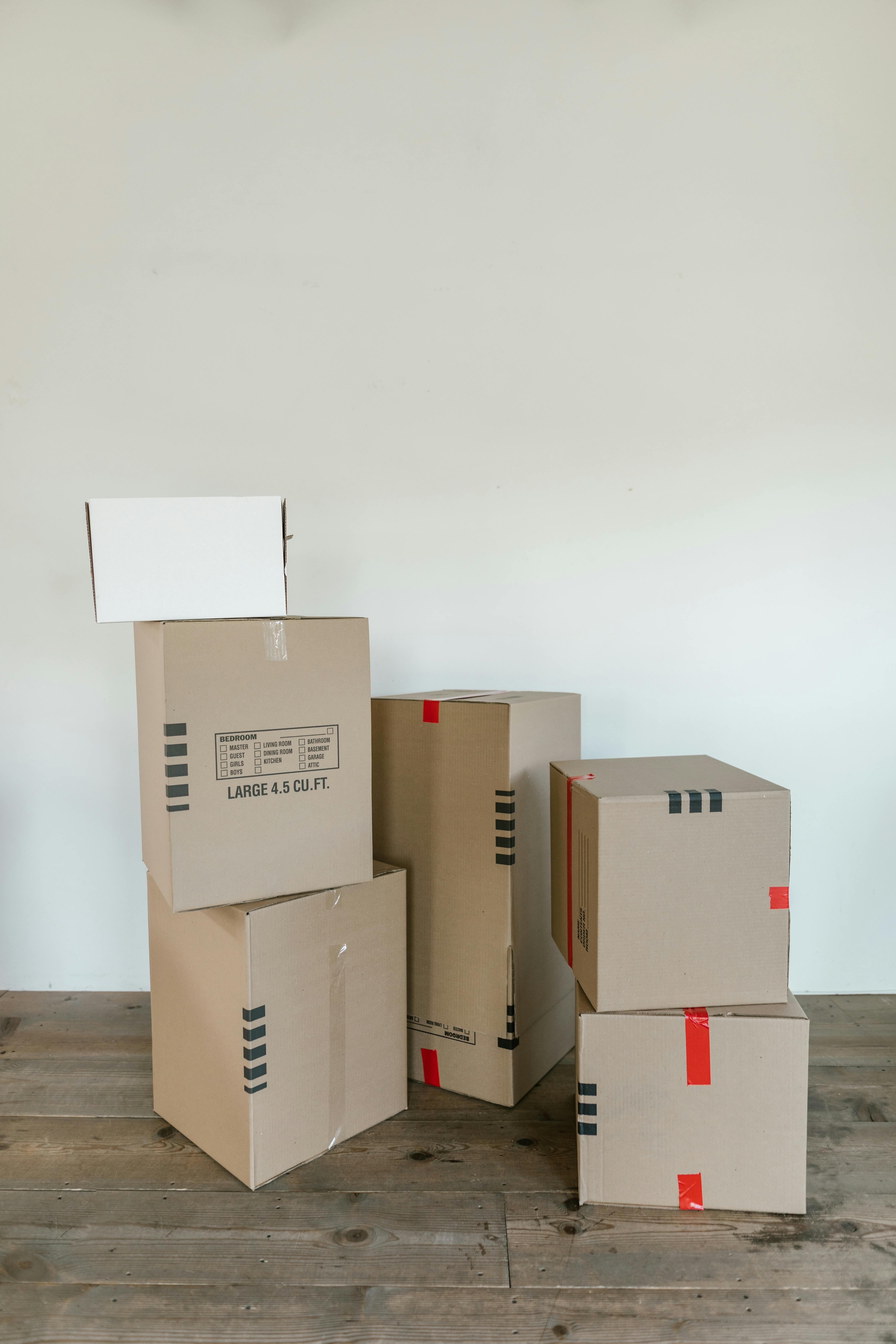 brown cardboard boxes on wooden floor