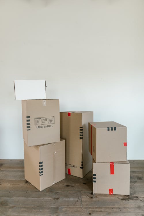 Brown Cardboard Boxes on Wooden Floor