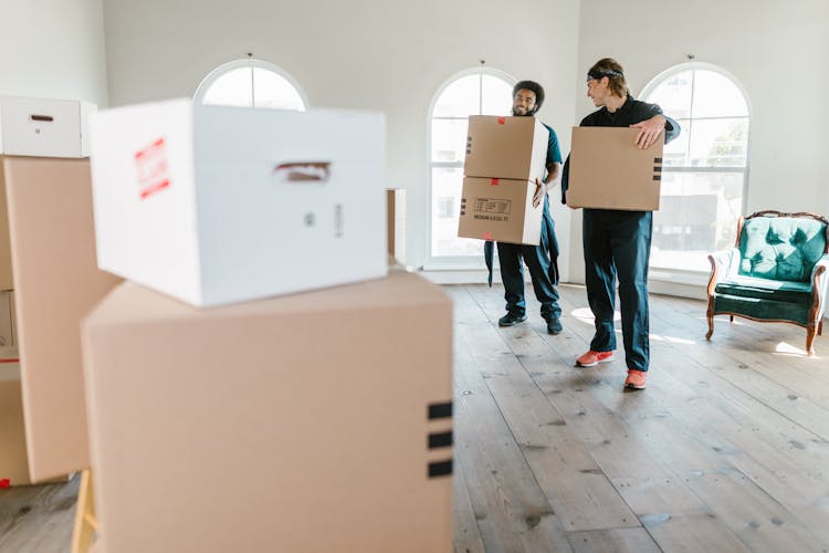 Two Men Carrying Boxes