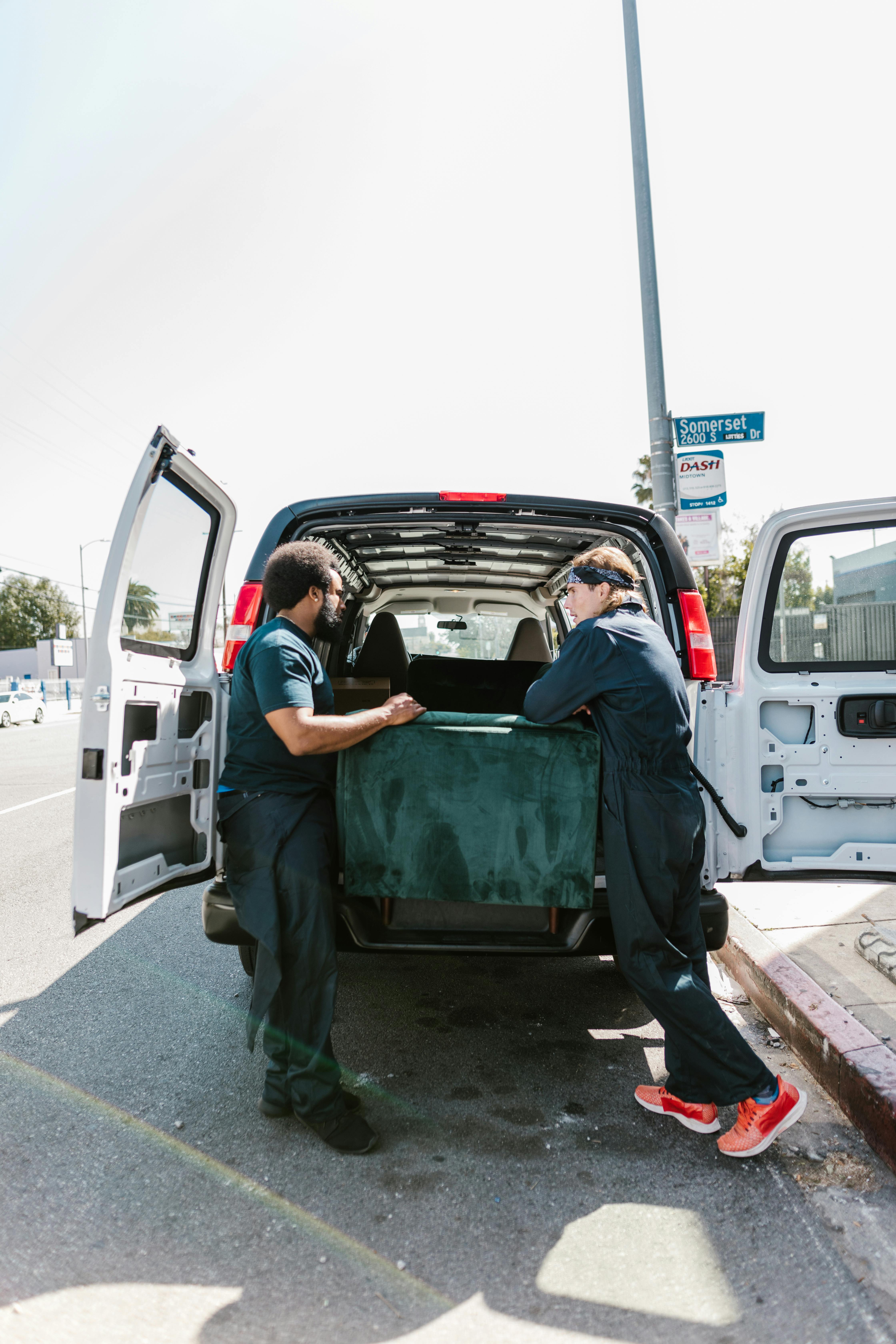 man in blue long sleeve shirt sitting on green car seat