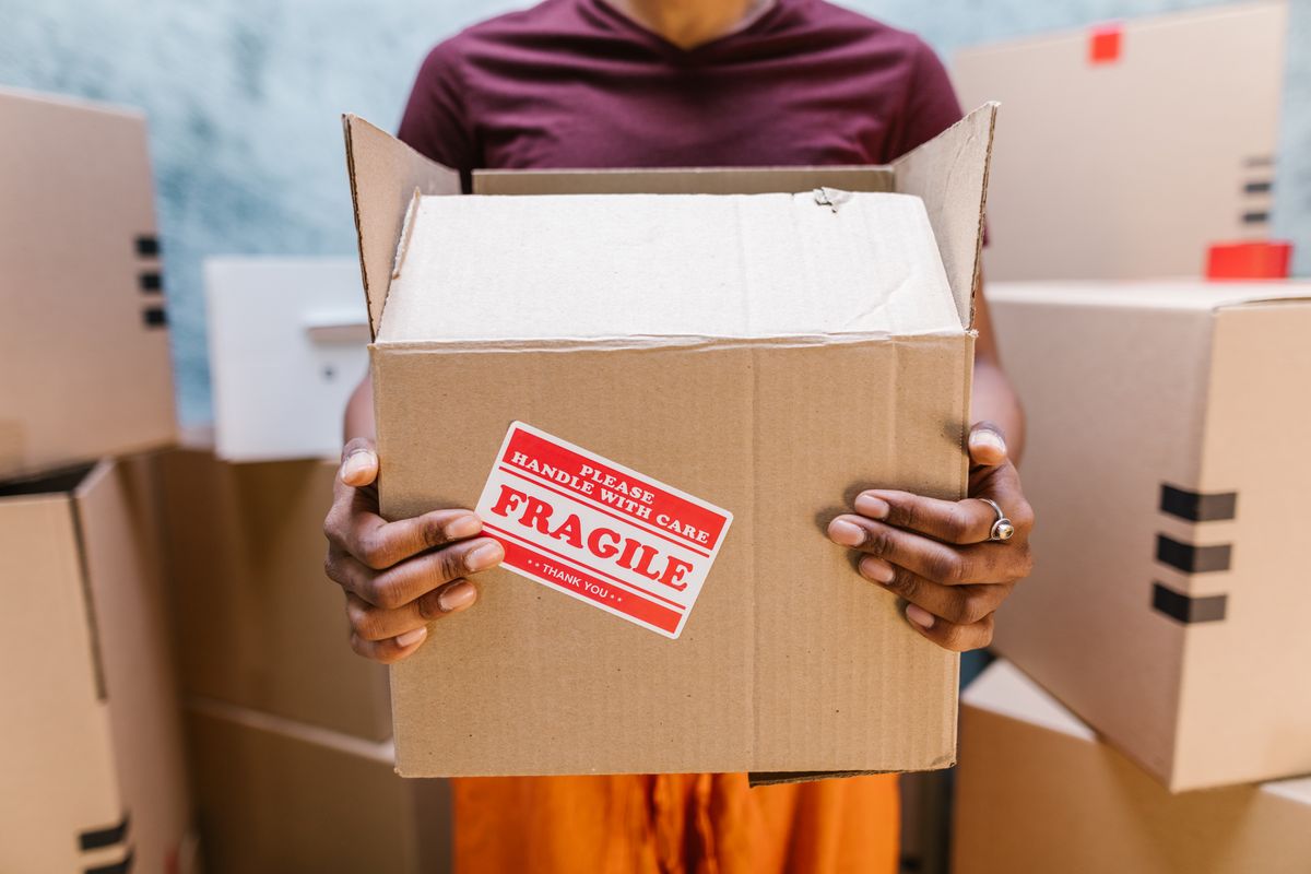 SwiftHaul Moving crew carrying labeled boxes through a Philadelphia apartment