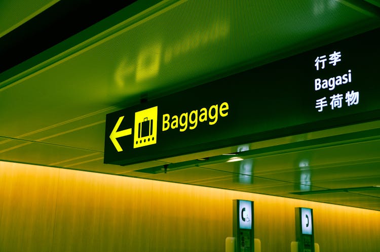 Close-up Photo Of Baggage Sign