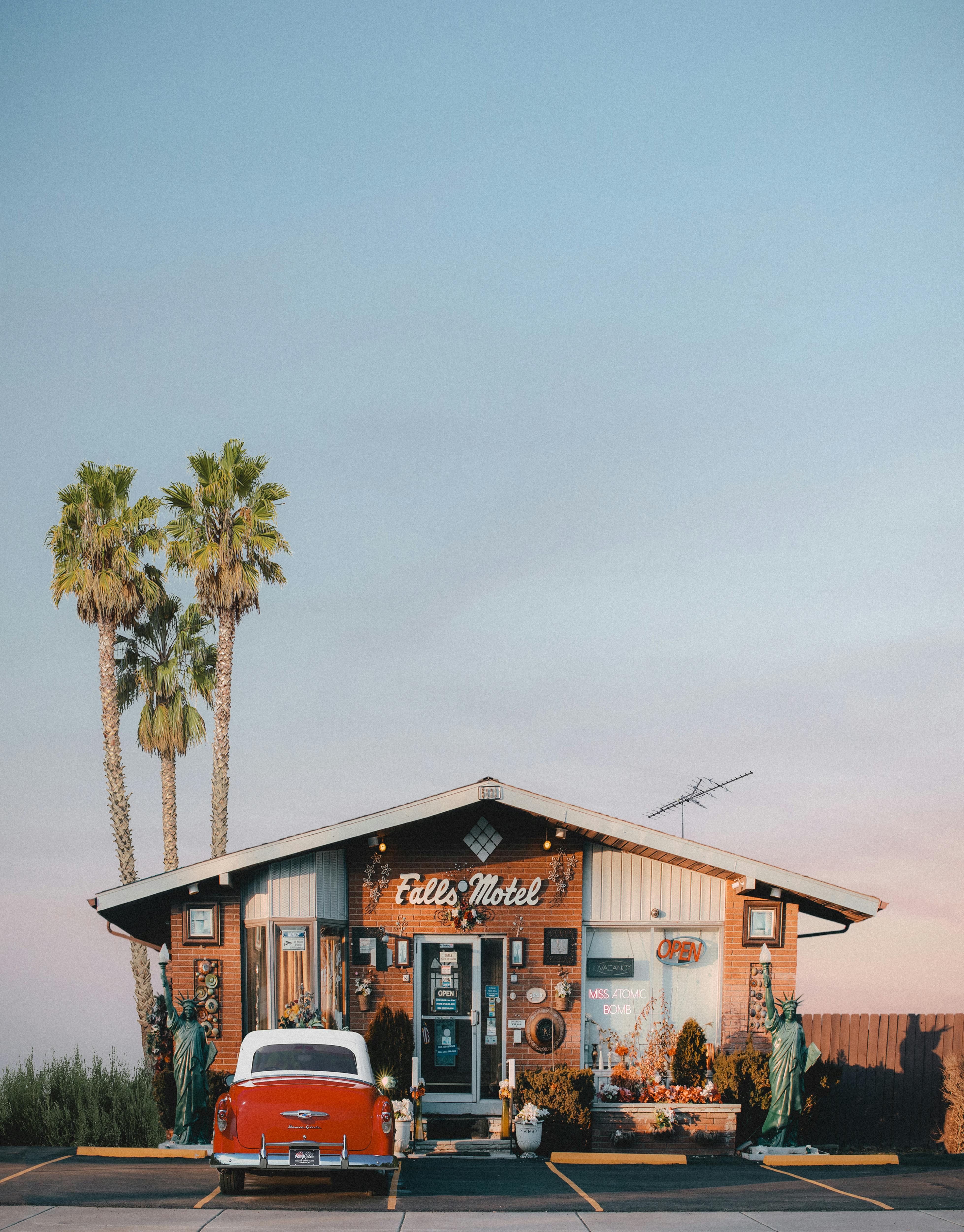 a hotel with wooden wall beside the palm trees