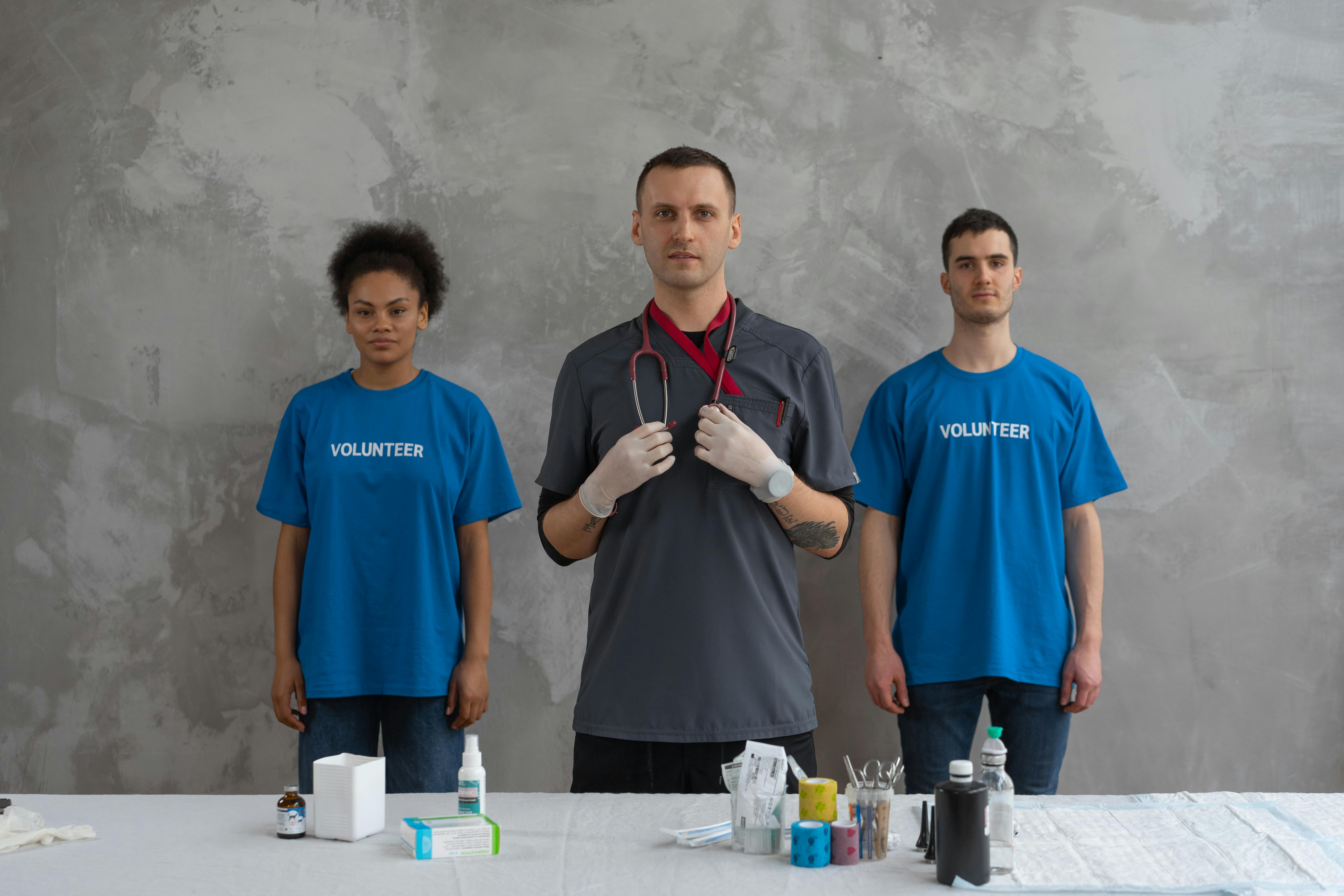 man in blue crew neck t shirt standing beside man in blue crew neck t shirt