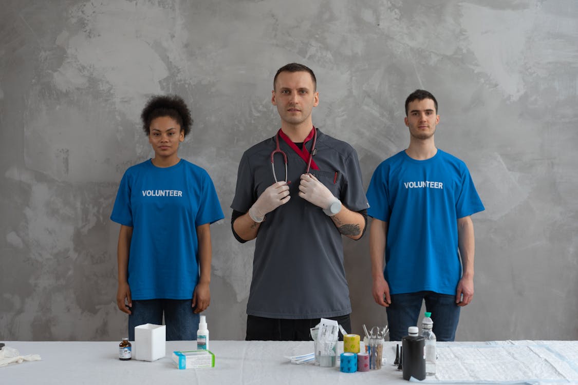 Man in Blue Crew Neck T-shirt Standing Beside Man in Blue Crew Neck T-shirt