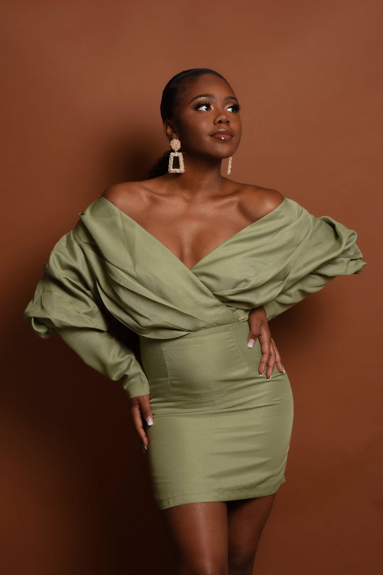 A Woman Wearing An Off Shoulder Dress 