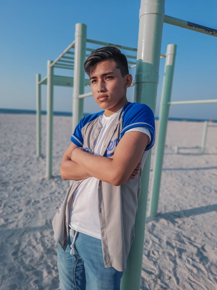 Man Standing Beside A Monkey Bar On A Beach