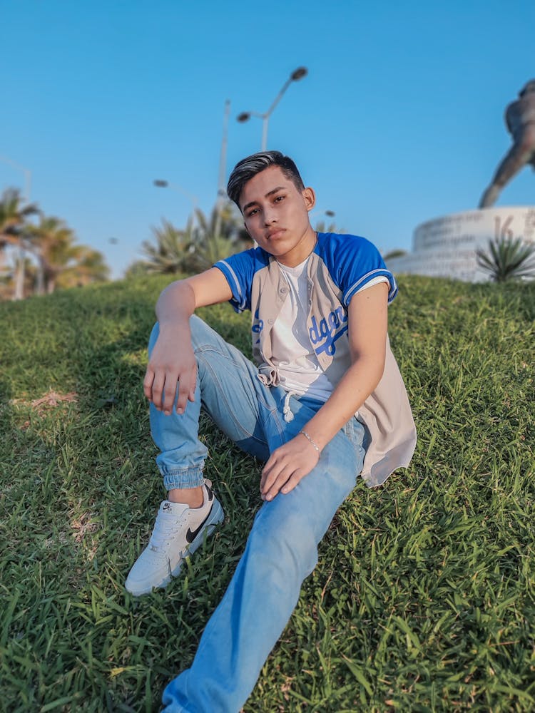 Photo Of A Boy In A Gray And Blue Jersey Posing On The Grass