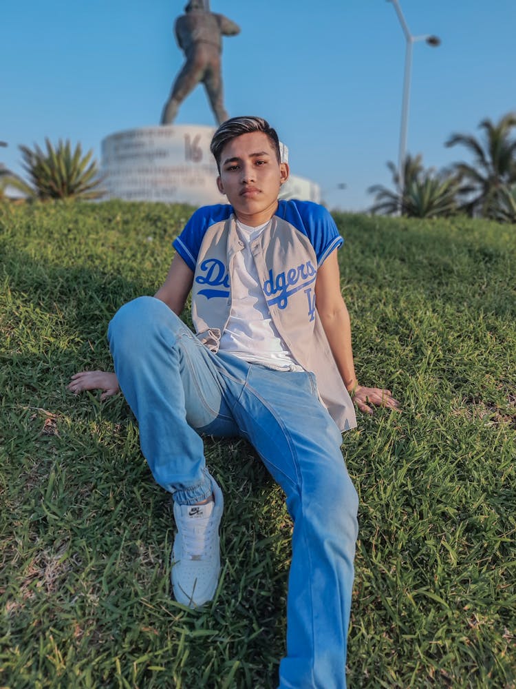 Photograph Of Boy Wearing A Gray And Blue Jersey And Denim Jeans