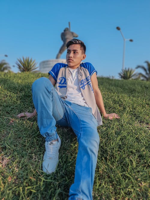 Photo of Teenage Boy Sitting on Grass