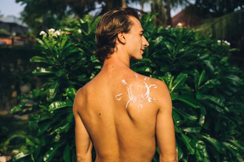 Free Shirtless Man with Sunscreen Stock Photo